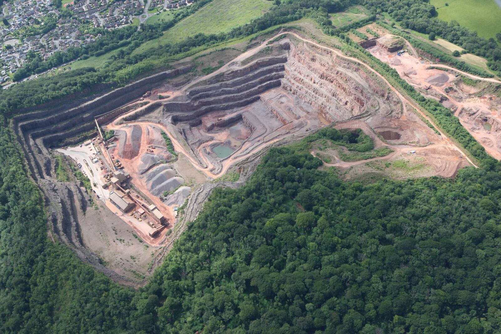 Aerial view across Taffs Well Quarry towards nearby housing