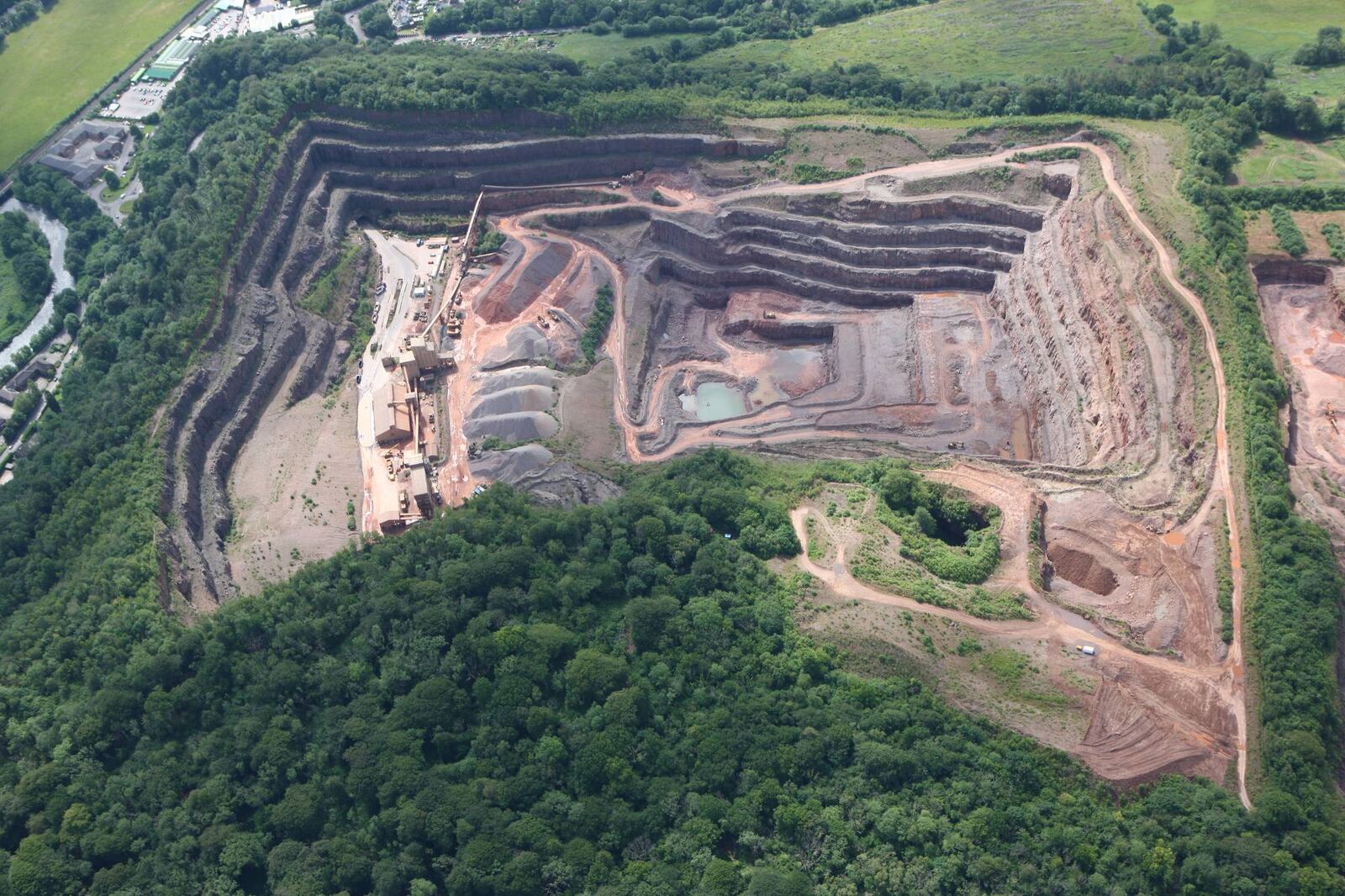 Aerial view of the quarry floor, processing plant and stockpiles at Taffs Well Quarry